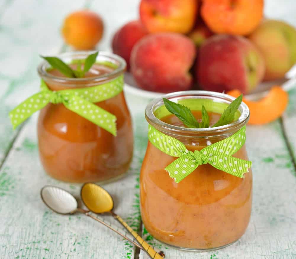 peach puree in a glass jar on a white table