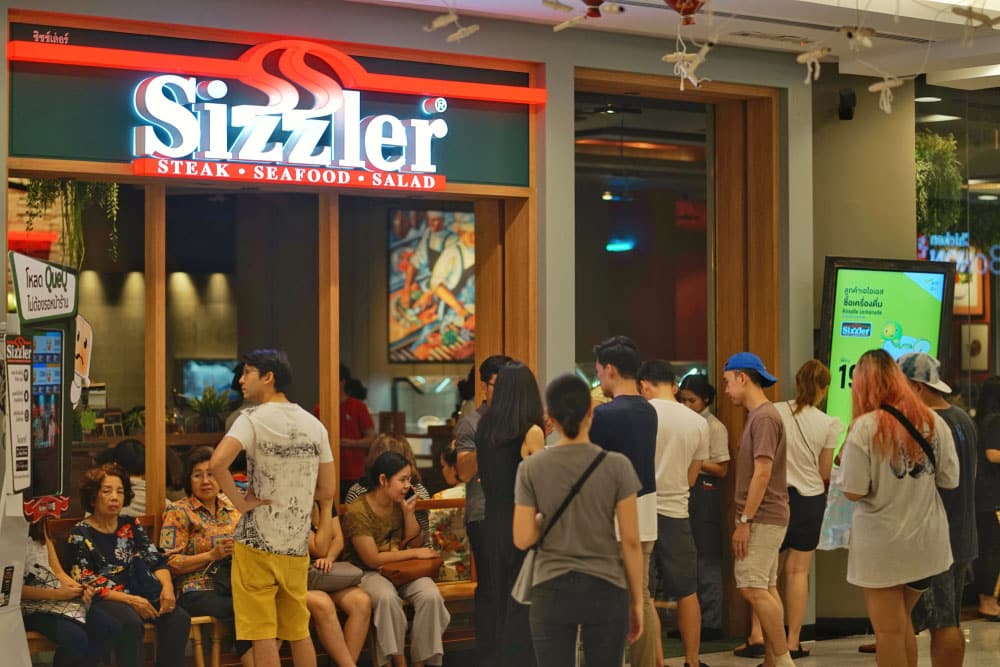 Unidentified people waiting to eat at Sizzler restaurant 