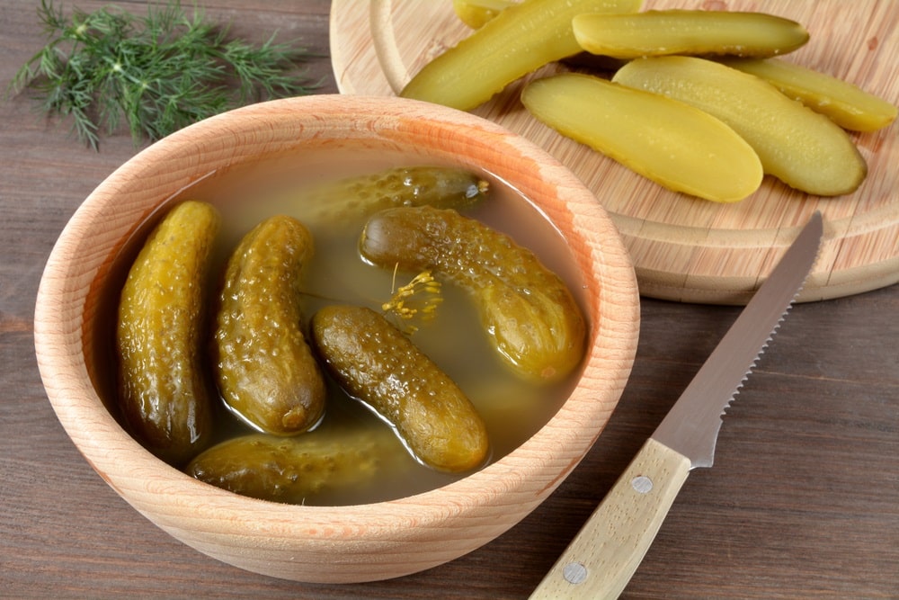pickled cucumbers with juice in a bowl