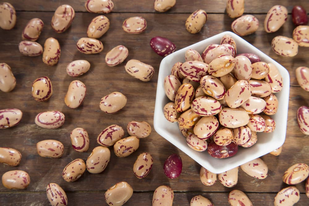 Pinto beans on wood bowl