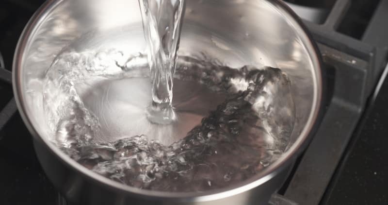 pouring water saucepan