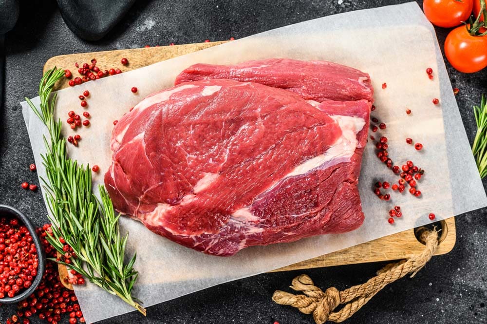 Raw Round beef cut on a cutting board