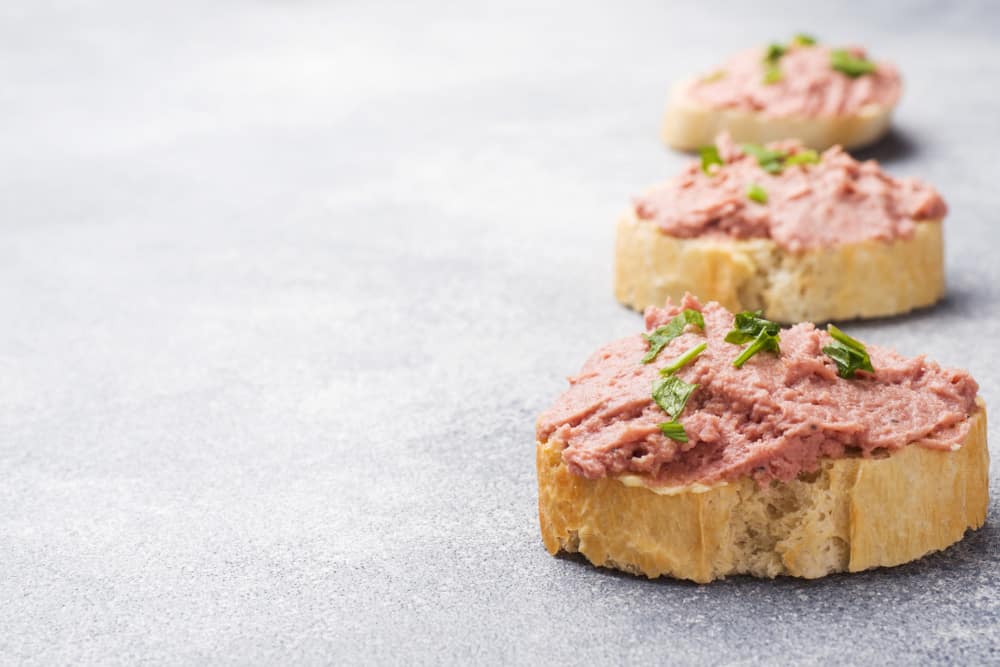 Sandwiches with chicken pate and butter on the table