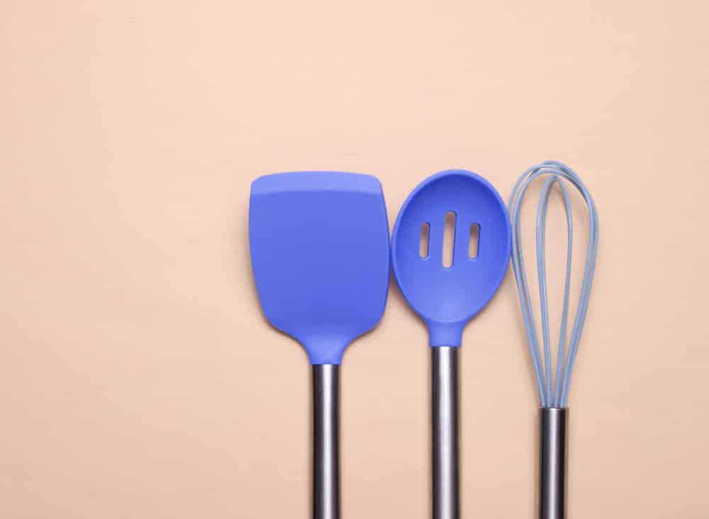 Set of tools for cooking on pink background