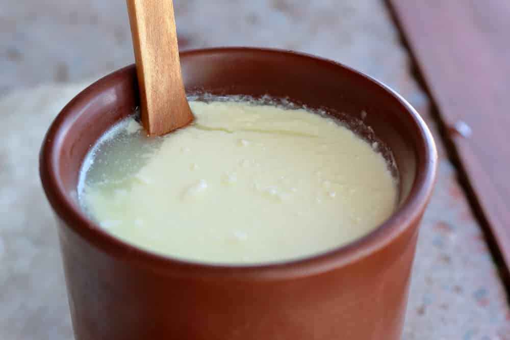 homemade soured milk in brown clay cup