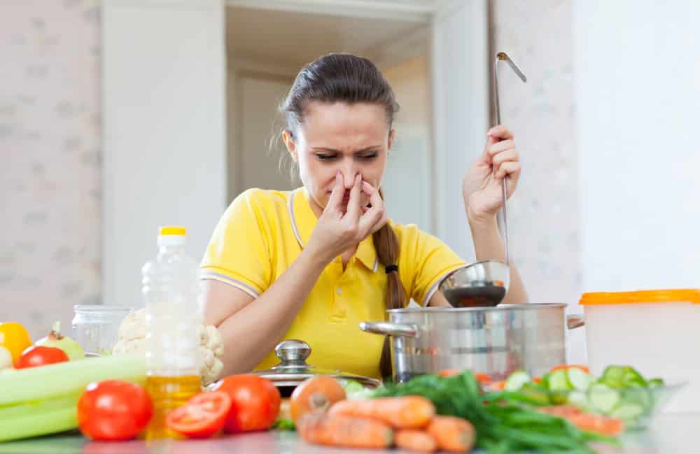 woman holding her nose because of bad smell