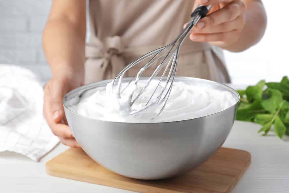 Woman whipping white cream