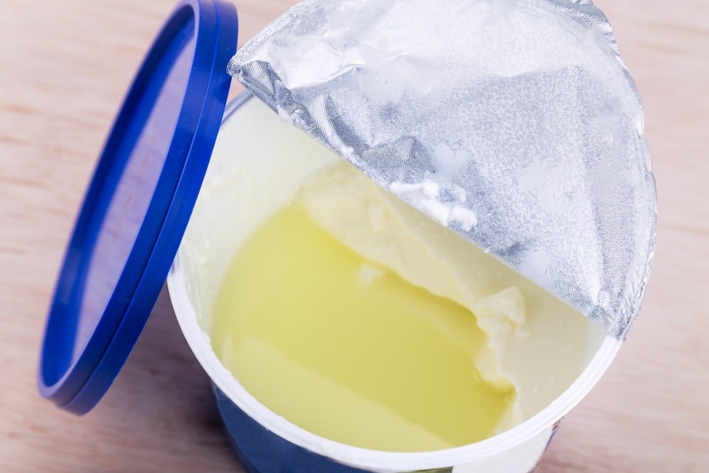 Layer of whey protein formed on top of packaged yogurt