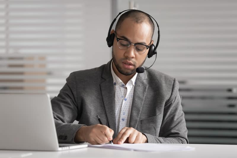 African customer support agent wear headset