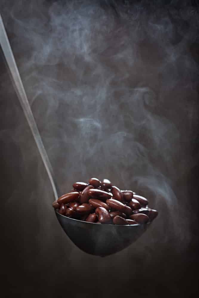 Cooked red kidney beans in a ladle with the effect of steam 