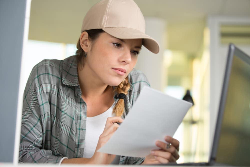 happy female worker checking manual