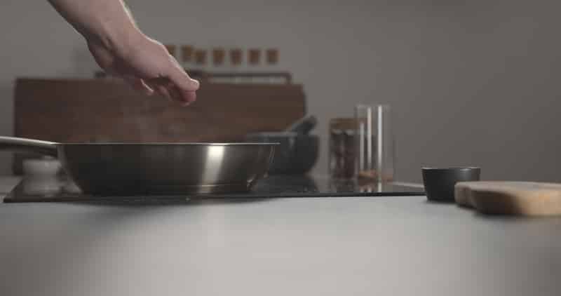 man hand checking temperature-steel pan