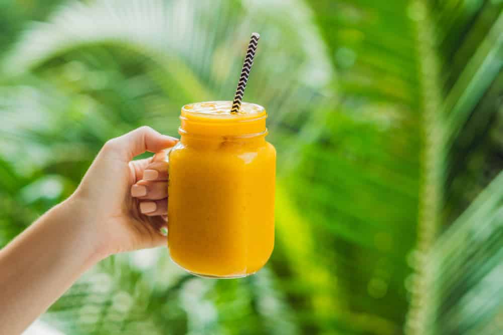 Mango smoothie in a glass Mason jar