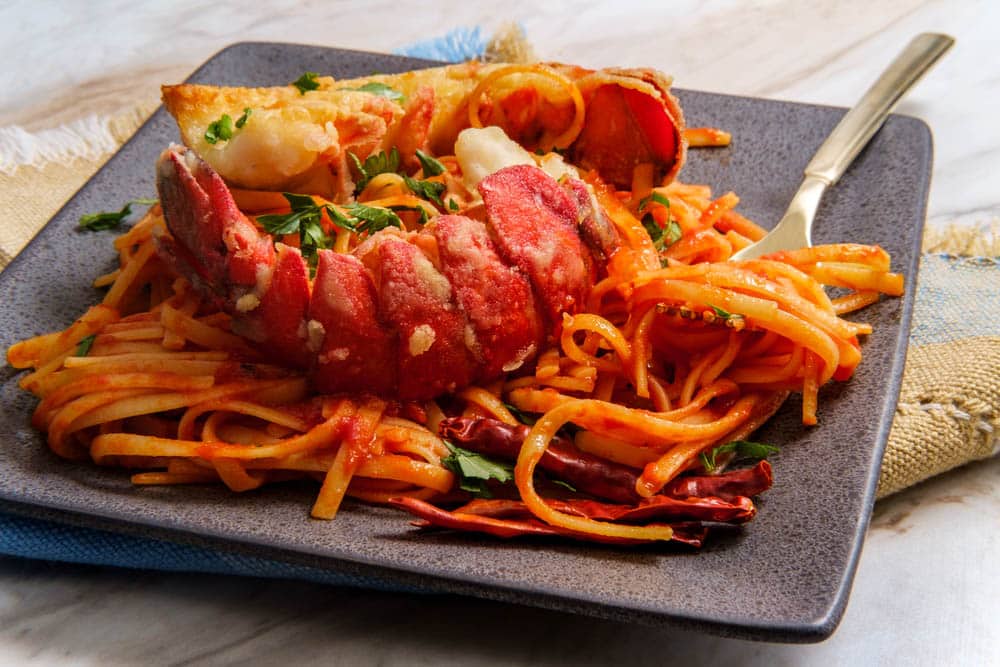 Pan fried sliced lobster tail fra diavolo linguine