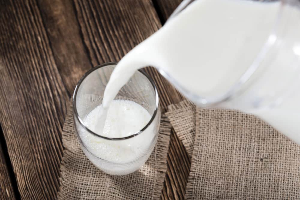 Portion of Milk on a dark wooden background