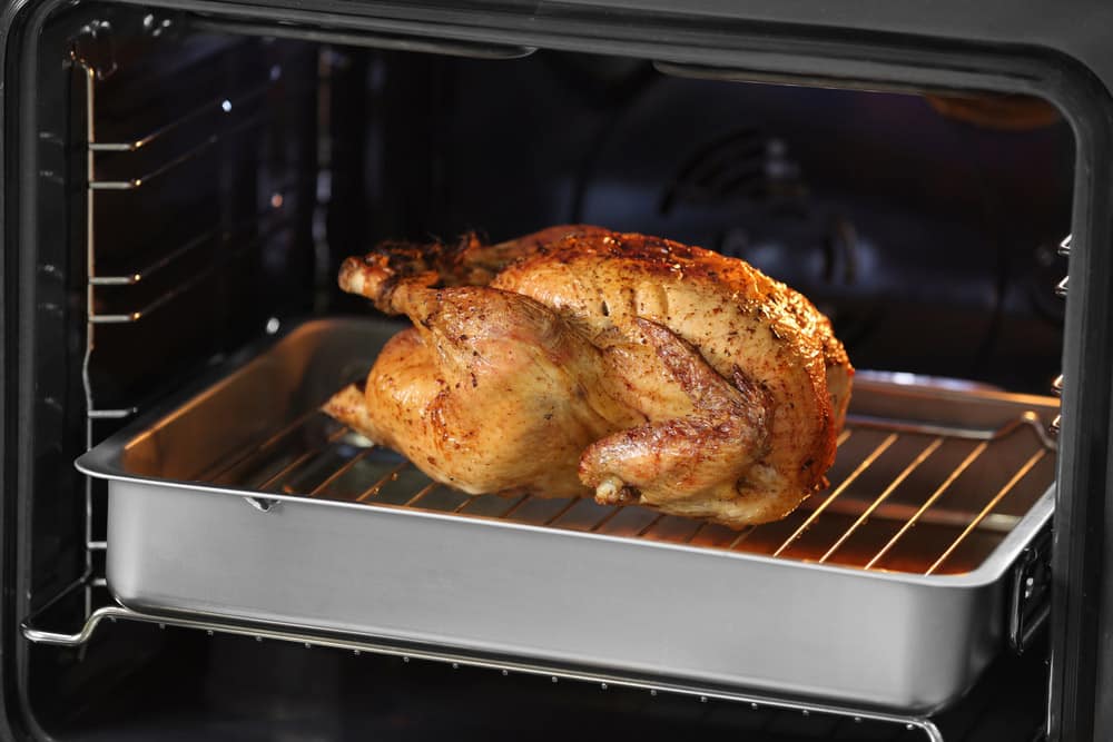 Golden roasted turkey on baking tray in oven