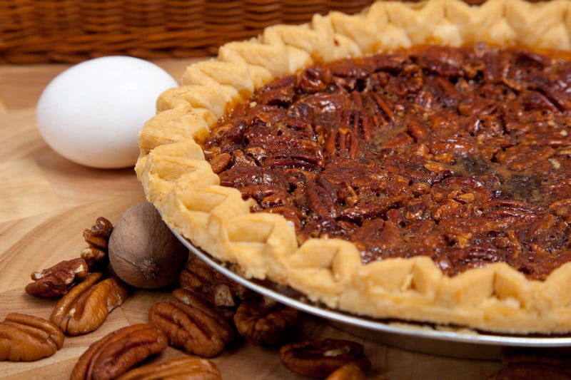 Homemade pecan pie with ingredients