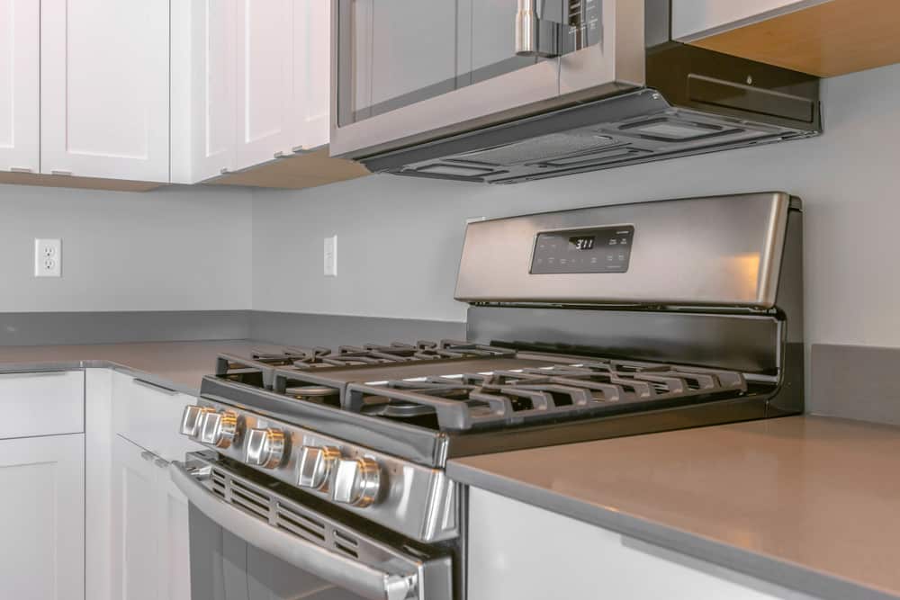 Range with cooktop and oven inside the modern kitchen of a new house