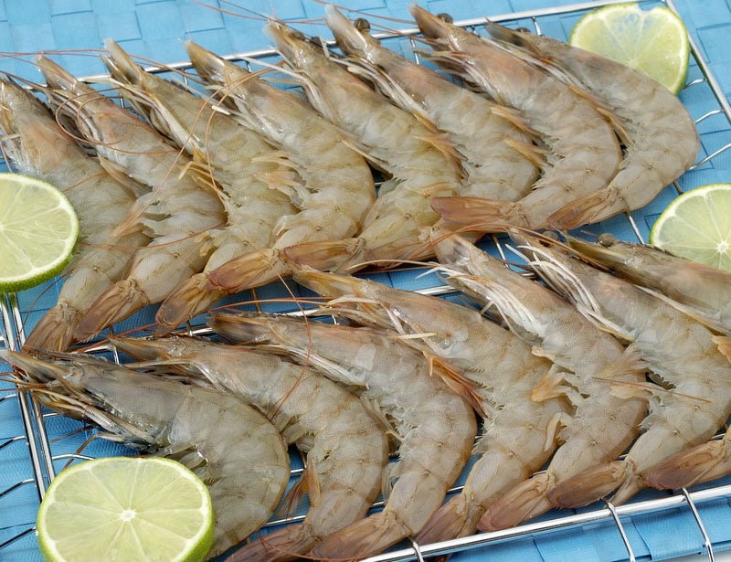Raw shrimp attractively layered on rack and garnished with lime