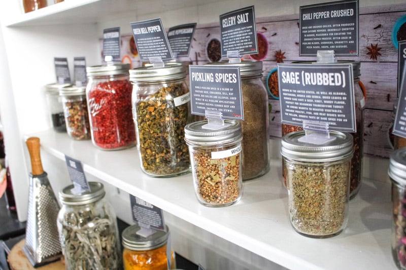 A view of several big jars of dried herbs and spice