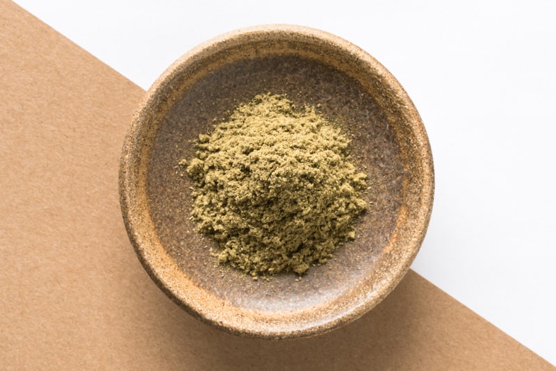 Top view of ground sage herb isolated in a bowl