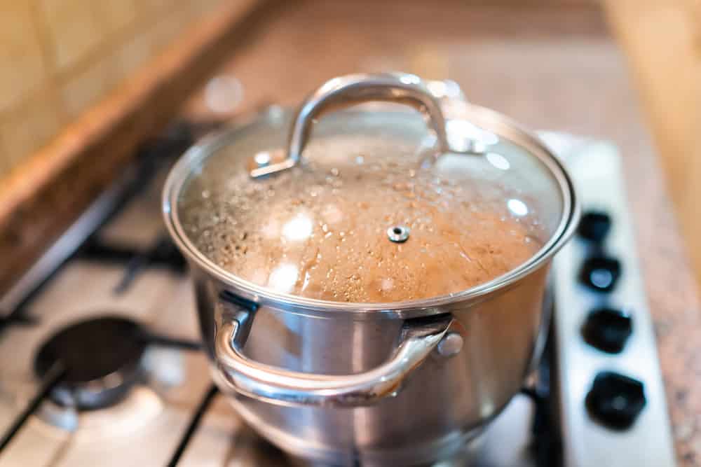 Closeup of closed lid cooking in pot