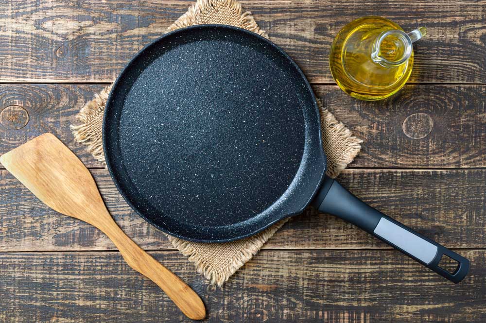 Culinary background with empty nonstick pancake pan