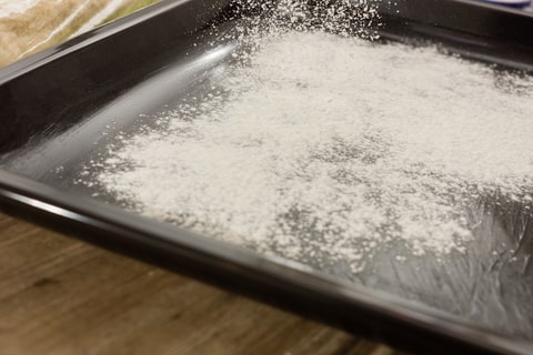Dusting flour over the tray