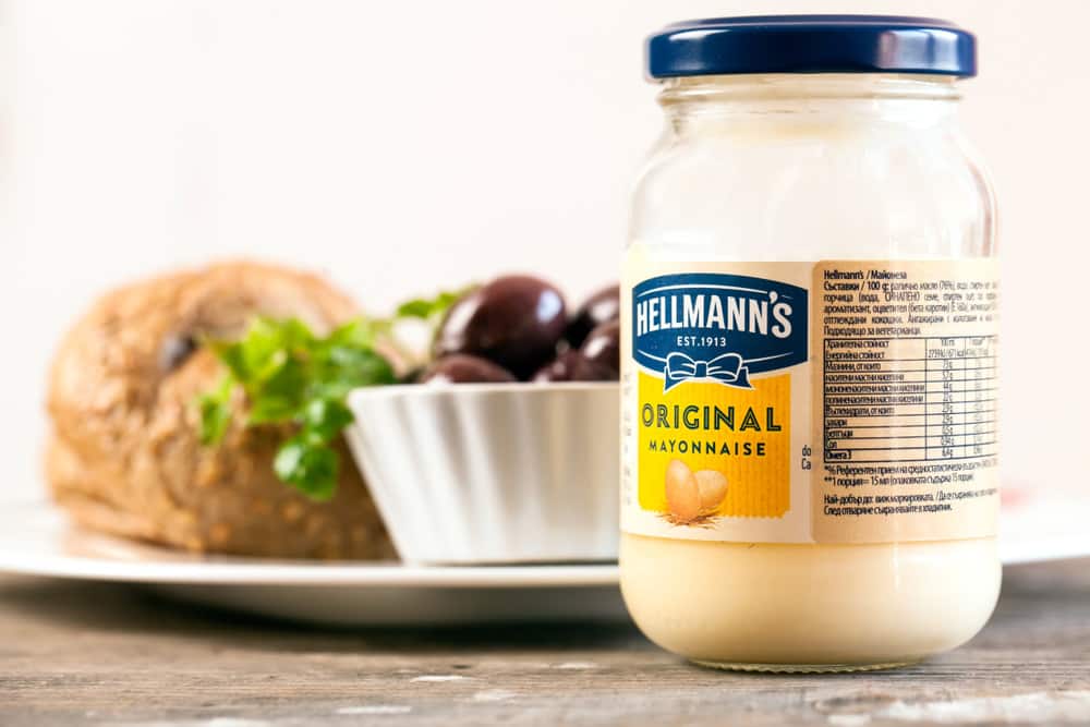 Jar of Hellmann's Mayonnaise in front of sandwich