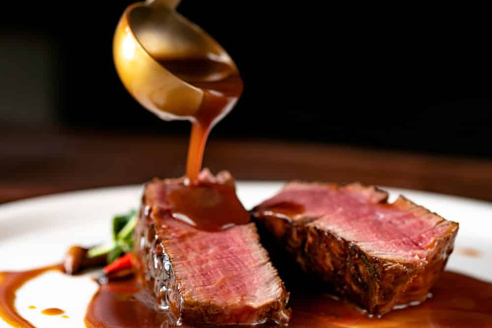 Grilled beef Steak filet Mignon pour demi-glace sauce