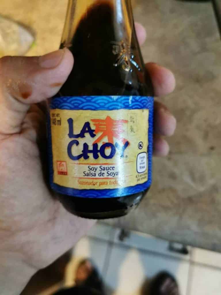 hand holding la choy sauce