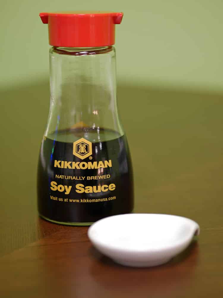 Kikkoman soy sauce and saucer on a table