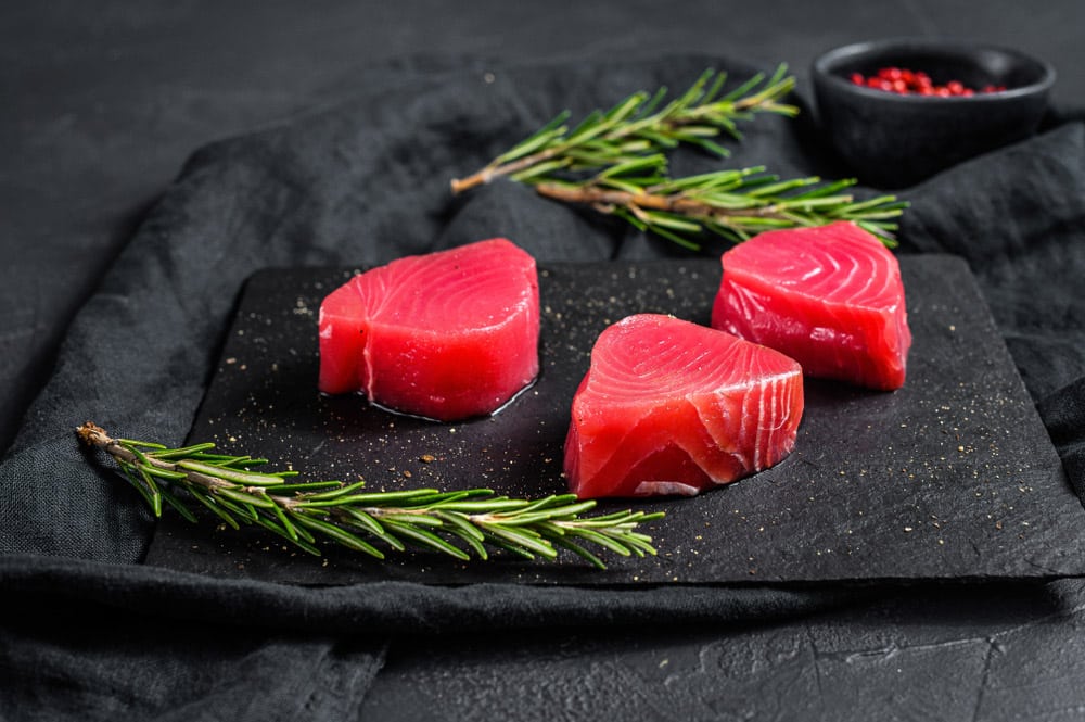 Raw red tuna steak. Black background