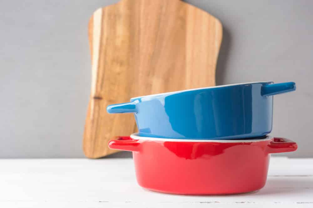 Stack of multicolored red and blue ceramic cooking pots