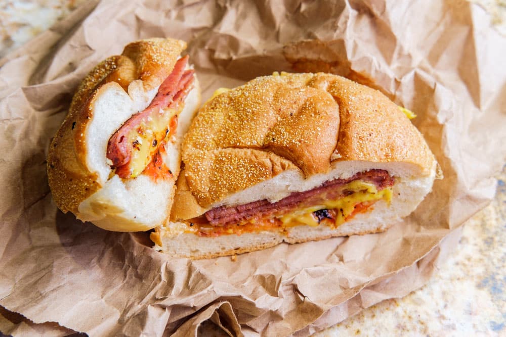 Taylor ham, pork roll, egg and cheese breakfast sandwich on a Kaiser roll