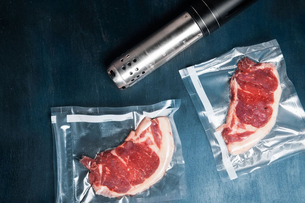 Two vacuum packed beef steaks with a sous vide roner