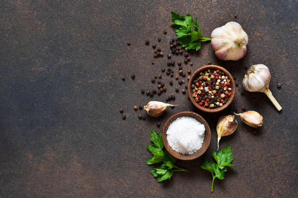 Pepper, salt, garlic in a wooden bowl 
