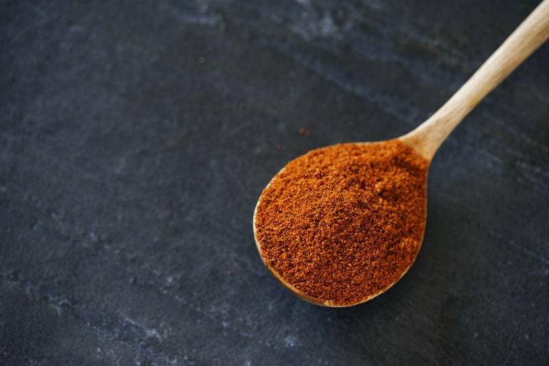 Close up of chili powder isolated on black background
