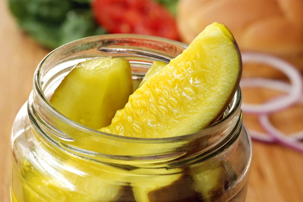 Dill pickle spears in open jar