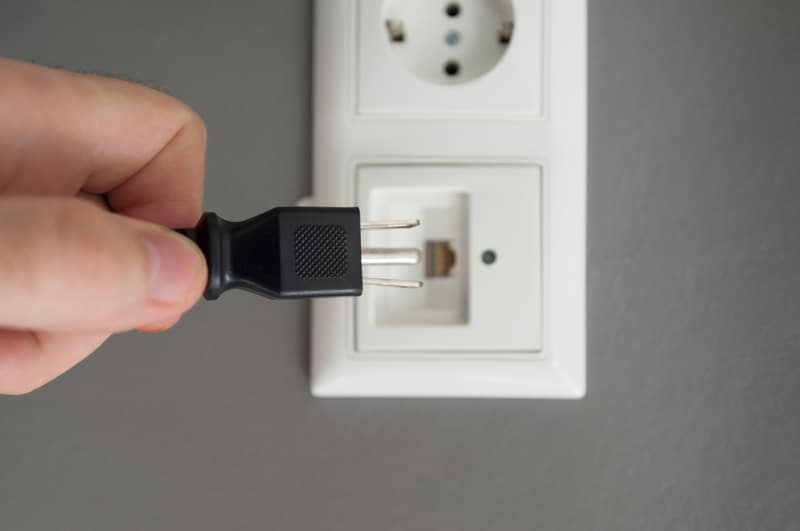 Inserting plug in outlet