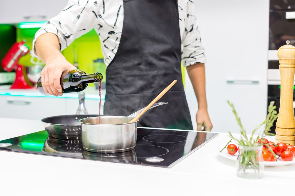 Man pouring wine in the pan