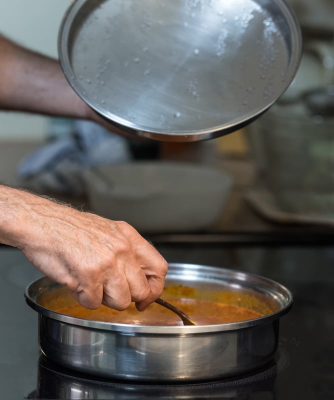 Man Stirring Pan on Stove top