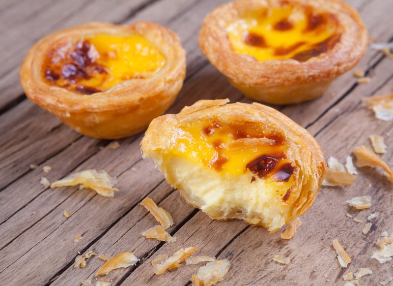 Delicious portuguese egg tart on wood background