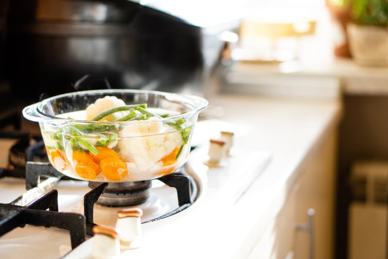 Transparent glass pan with vegetable soup