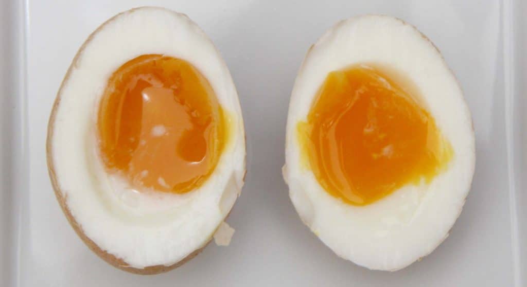 Undercooked hardboiled egg cut in half