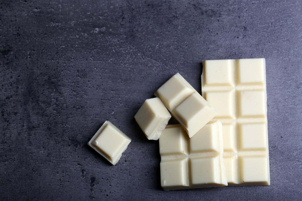 White chocolate pieces on gray background