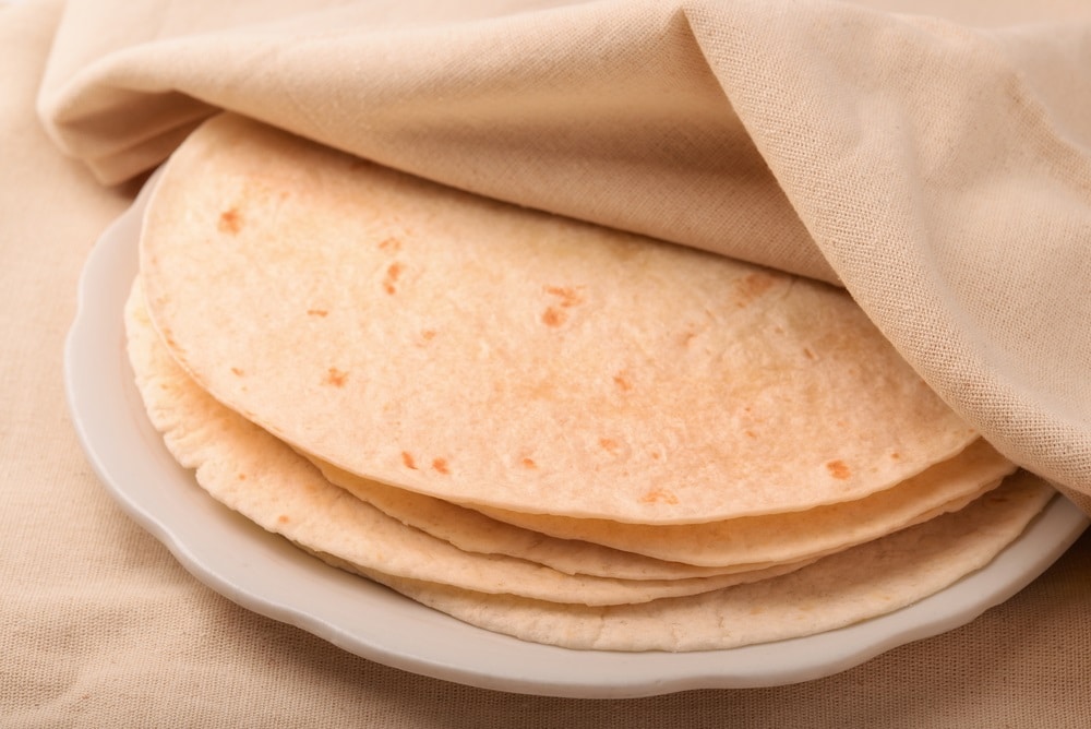 Stack of tortilla covered with neat cloth