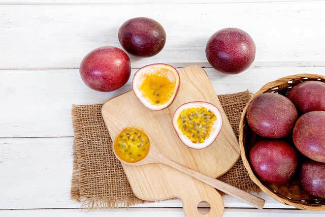 Close up fresh passion fruit on white wooden table background