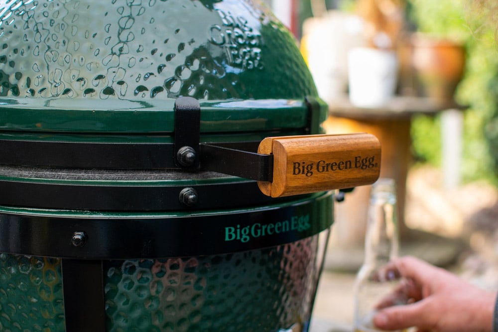 Close up image of a handle of The Green Egg outdoor barbecue