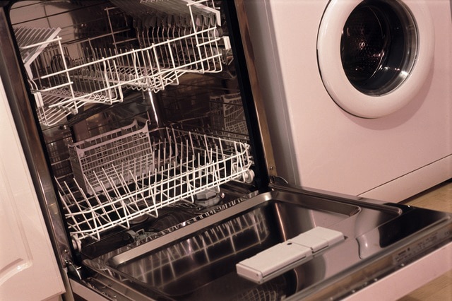 Stainless steel interior and racks of an empty dishwasher